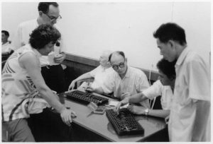 Alan Perlis (seated) and Herbert Simon (standing left) meeting with Chinese computer scientists, 1972