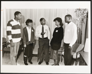 Robert Lee, Assistant Dean for Minority Students, conversing with four recently accepted Black students, 1988.