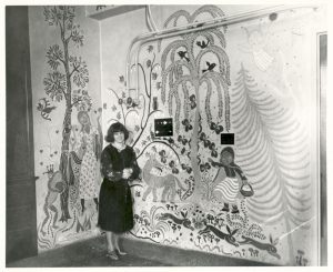 Artist Gisella Loeffler poses with her work