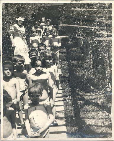 Patients and nurse walking along a wooden path, Ridge Farm, St. Louis Children's Hospital.
