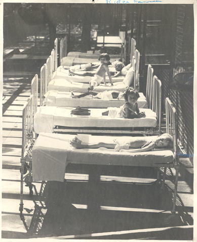 Patients in beds on a sun porch, Ridge Farm, St. Louis Children's Hospital.